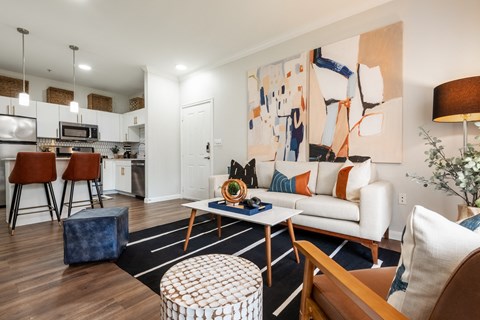 an open living room and kitchen with a couch and a table